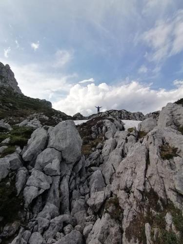 a person standing on top of a rocky mountain at Lûc dal Aur in Sùtrio