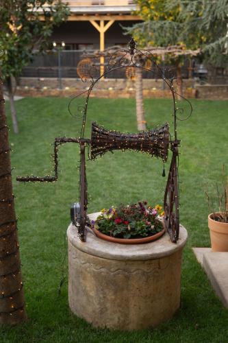 a planter with a bowl of flowers in a garden at Garden's House Pozar in Aridaia in Aridaia