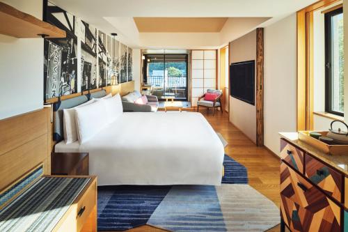 a bedroom with a large white bed in a room at Hotel Indigo Hakone Gora by IHG in Hakone