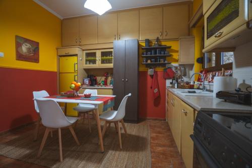 a kitchen with a table and chairs and a refrigerator at Garden's House Pozar in Aridaia in Aridaia