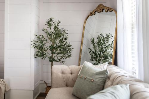 a living room with a couch and a mirror at Walkable to Everywhere in Little Italy- Near CWRU and Cleveland Clinic Main Campus in Cleveland