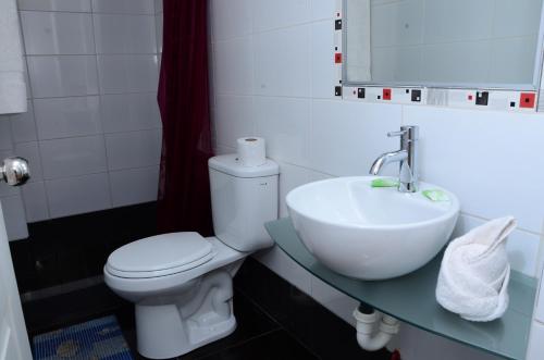 a bathroom with a toilet and a sink at Golden Inca Hotel in Cusco