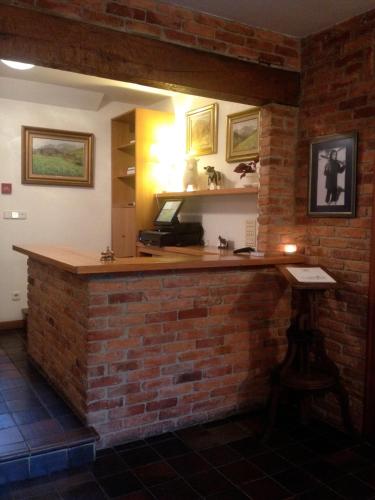 a brick bar in a room with a brick wall at Hotel El Jisu in Camaleño