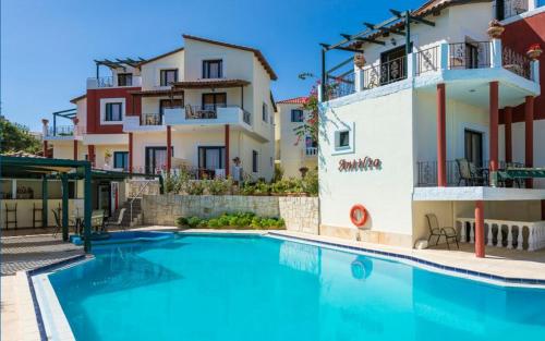 a large swimming pool in front of a building at Antilia Apartments in Tavronitis