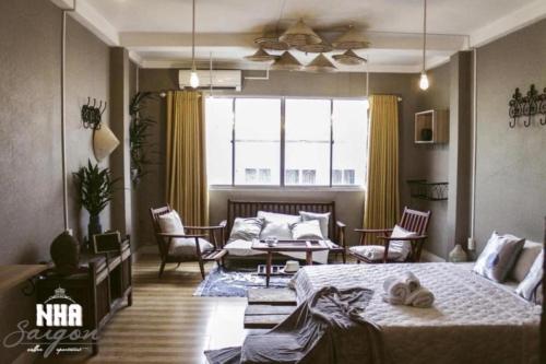 une chambre avec un lit et un salon dans l'établissement Nhà Saigon Homestay&Coffee, à Hô-Chi-Minh-Ville