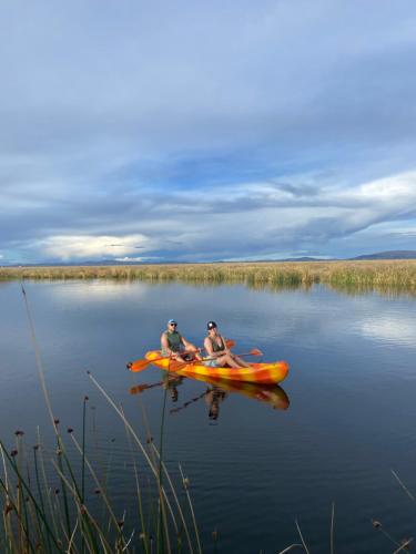 two people in a kayak on a lake at Uros Titicaca Beluxia in Puno