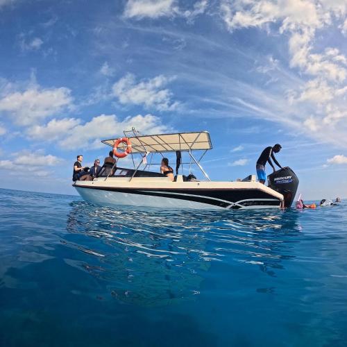 a group of people on a boat in the water at Blue Water Thoddoo Inn in Thoddoo