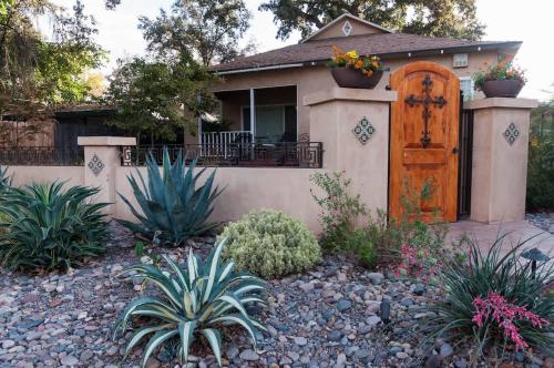 a house with a wooden door and some plants at Seq Parks-House with Hot Tub Fire Pit Koi Pond Outdoor Kitchen in Visalia