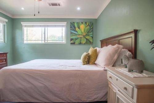 a bedroom with a bed with two stuffed animals on it at Seq Parks-House with Hot Tub Fire Pit Koi Pond Outdoor Kitchen in Visalia