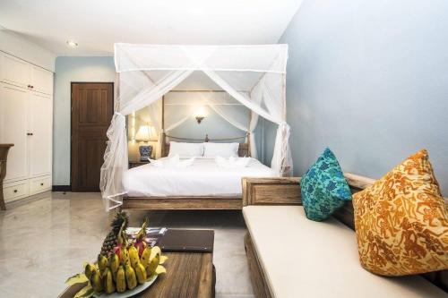 a bedroom with a bed with a canopy at Moubillow Resort in Ao Nang Beach