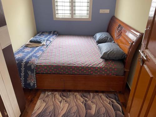 a small bed in a small room with a bed sidx sidx sidx at service apartment in Bengaluru