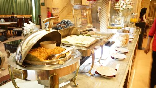 ein Buffet mit vielen verschiedenen Speisen in der Unterkunft Hotel Indah Palace Solo in Solo