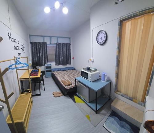 a room with a bedroom with a bed and a desk at 104 Peaceful and Cosy apartment with cool fan near BTS with free WiFi in Bangkok