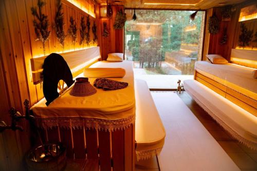 a train room with two beds and a window at Wyndham Residences Aqkol in Akkol'