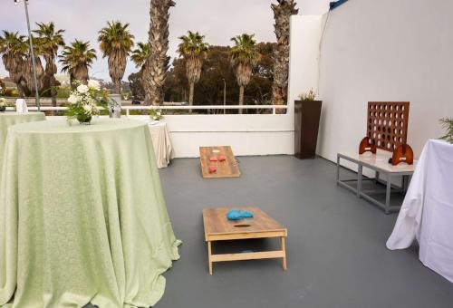 a room with a table with a green table cloth at Hilton Garden Inn Dana Point Doheny Beach in Dana Point
