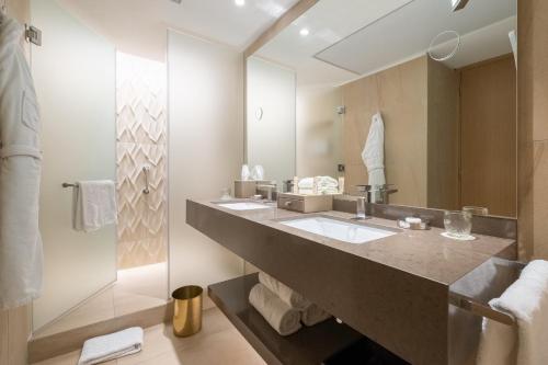 a bathroom with two sinks and a large mirror at Mandarin Oriental, Santiago in Santiago