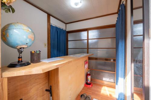 a room with a desk with a globe on it at 二条駅から徒歩10分 in Kyoto