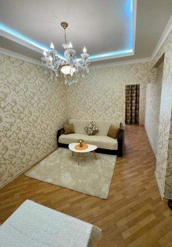 a living room with a couch and a table at Friends Premium HOSTEL in Baku