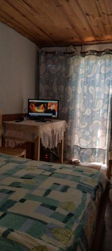a bedroom with a bed and a window with a curtain at IVATO Airport STUDIOS CHAMBRES in Ivato