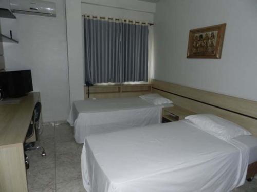 Ένα ή περισσότερα κρεβάτια σε δωμάτιο στο Hotel Estrela Palmas