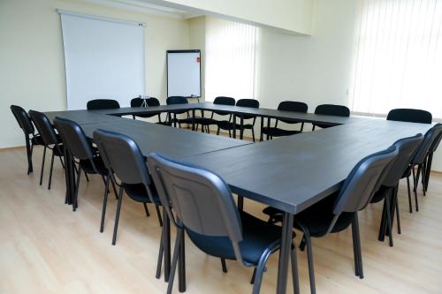 a conference room with a long table and chairs at Hotel Bulgaria in Kŭrdzhali