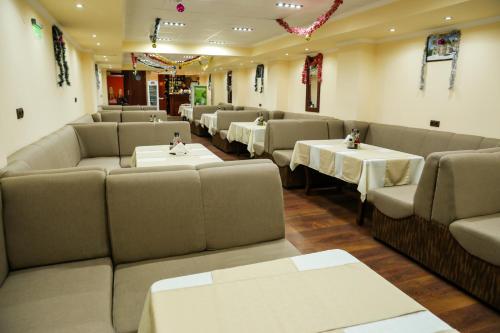 a dining room with tables and couches and tablesktop at Hotel Bulgaria in Kŭrdzhali