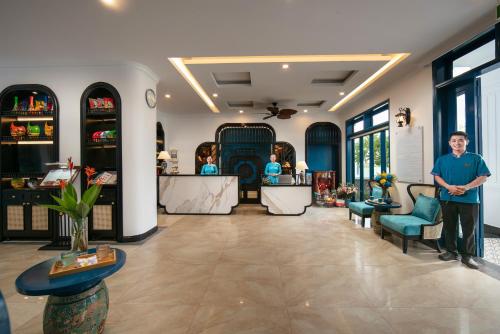 a man standing in the middle of a store lobby at Silk River Hoi An Hotel & Spa in Hoi An