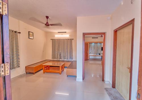 a living room with a table in the middle of it at Ushasree Wayanad Pool Resort by VOYE HOMES in Ambalavayal