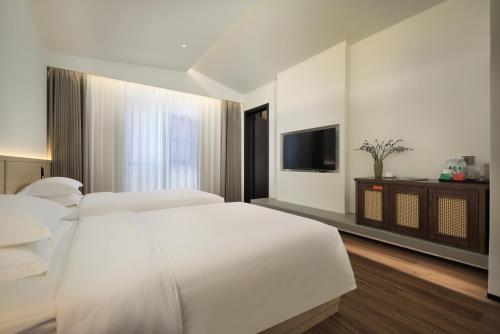 Ένα ή περισσότερα κρεβάτια σε δωμάτιο στο Riverbank Hotel