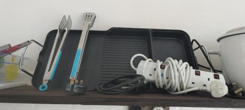 a tray with utensils on top of a table at CC HOMESTAY PRIVATE POOL Kampung Mangkuk, Terengganu in Penarek