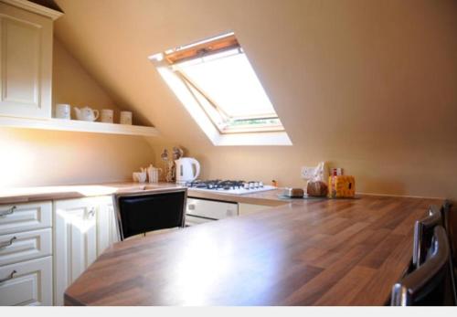 a kitchen with a wooden counter top and a window at Skellig Port Accomodation - 2 Bed Apartment in Portmagee