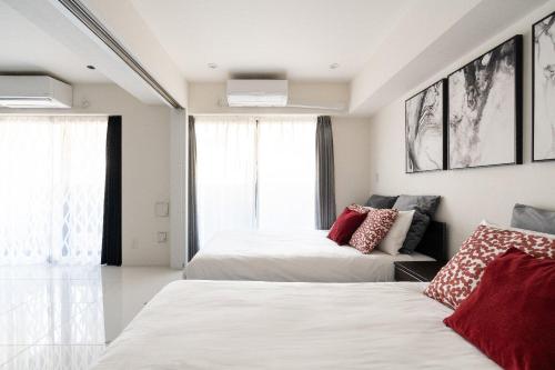 a bedroom with two beds and a couch at CREAL premier Akasaka in Tokyo