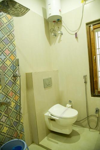 a bathroom with a toilet and a shower at Prabash Atithi Griha in Guwahati