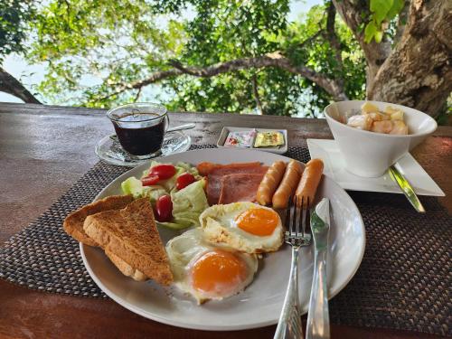 a plate of breakfast food with eggs bread and toast at Velora Bay Koh Jum in Ko Jum