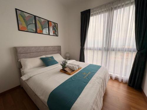 a bedroom with a large bed with a tray on it at Peaceful Escape Near IOI Mall Putrajaya in Sepang