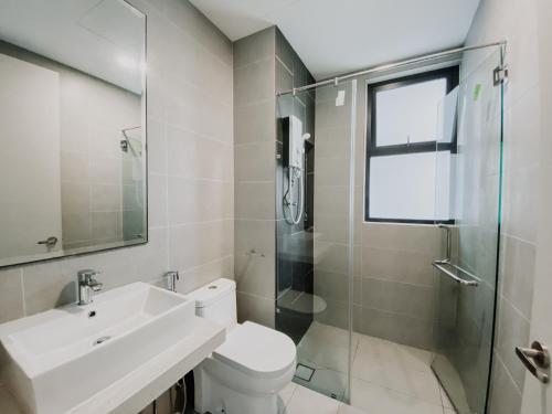 a bathroom with a toilet and a sink and a shower at Peaceful Escape Near IOI Mall Putrajaya in Sepang