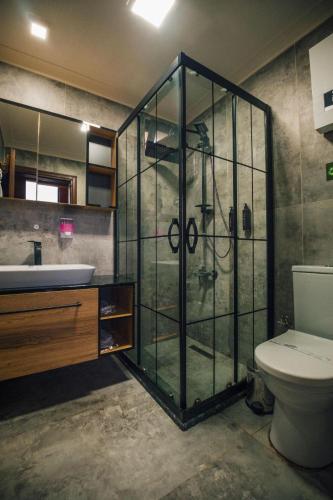 a bathroom with a shower and a toilet and a sink at Woodlodge Country Sapanca in Sapanca