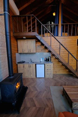 a stove in a room with a kitchen and a staircase at Woodlodge Country Sapanca in Sapanca