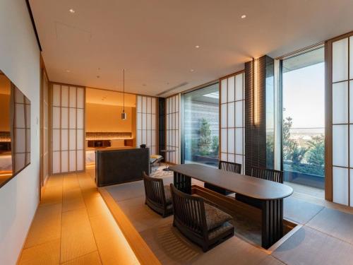 a dining room with a table and chairs at GREENITY IWATA in Iwata