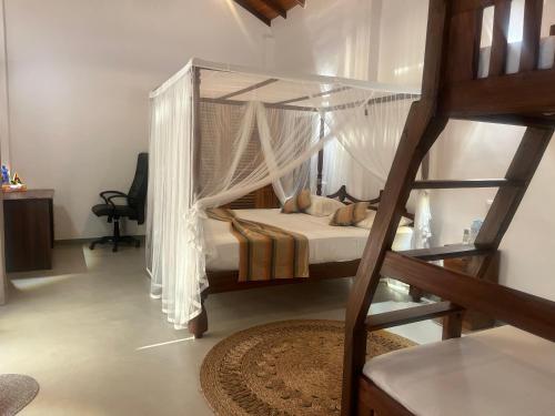 a bedroom with a bunk bed with a ladder at Turtle Beach Club in Pelena