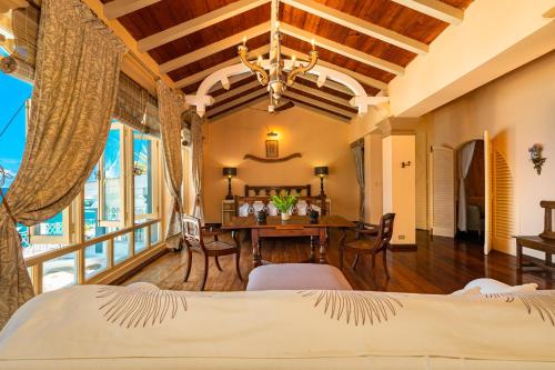 a bedroom with a table and a dining room at Blue Rhapsody Villa in Glacis