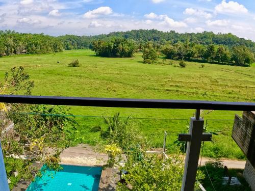 a view of a field from the balcony of a house at The Quale Villa in Galle