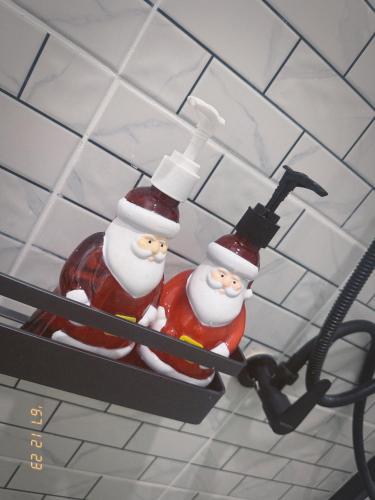 two christmas decorations are hanging on a wall at Zeevila in Sattahip