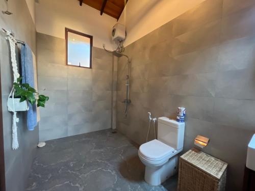 a bathroom with a toilet and a shower at Turtle Beach Club in Pelena