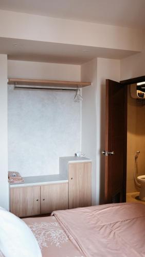 a bedroom with a bed and a large window at 3BR Apartemen Sudirman Bandung in Bandung