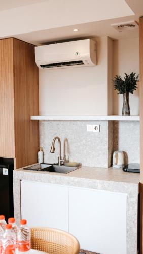 a kitchen with a sink and a counter top at 3BR Apartemen Sudirman Bandung in Bandung