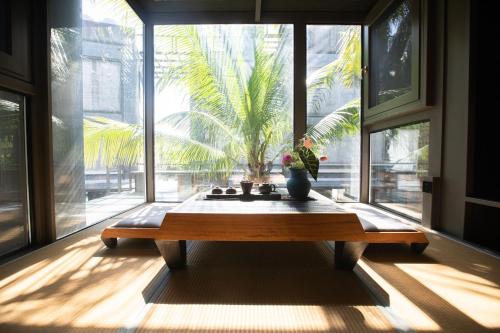 a room with a table in front of a large window at Sanya Yalong Bay Danqiu Castle Manor Hotel in Sanya