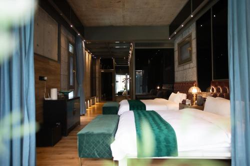 a bedroom with two beds with green and white sheets at Sanya Yalong Bay Danqiu Castle Manor Hotel in Sanya