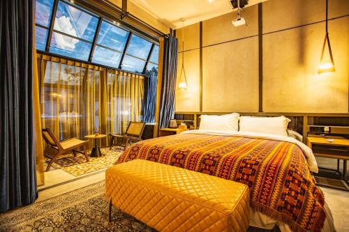 a bedroom with a bed and a large window at Sanya Yalong Bay Danqiu Castle Manor Hotel in Sanya