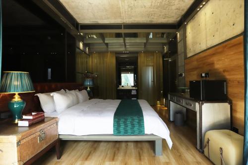a bedroom with a large bed and a television at Sanya Yalong Bay Danqiu Castle Manor Hotel in Sanya